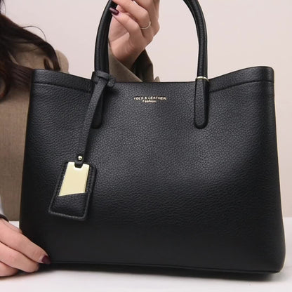 Elegant black handbag with adjustable strap and zipper closure